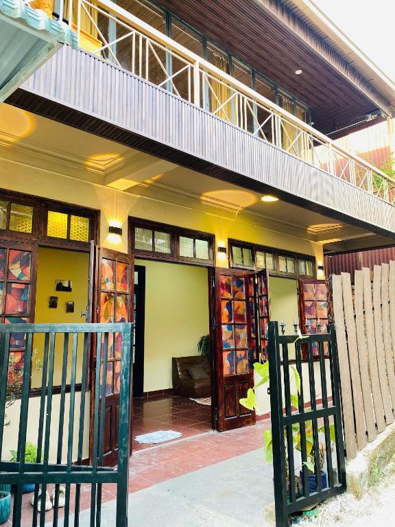 a building with a balcony on top of it at Maison MAY Đà Lạt in Da Lat