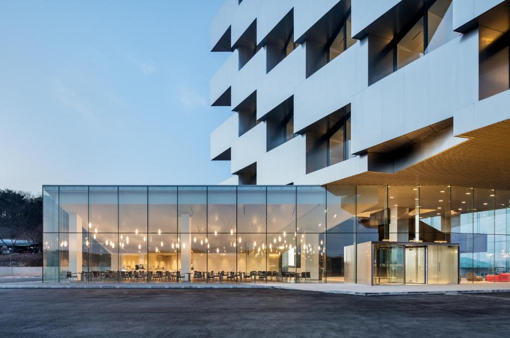 an office building with a large glass facade at Hotel Ora Incheon in Incheon