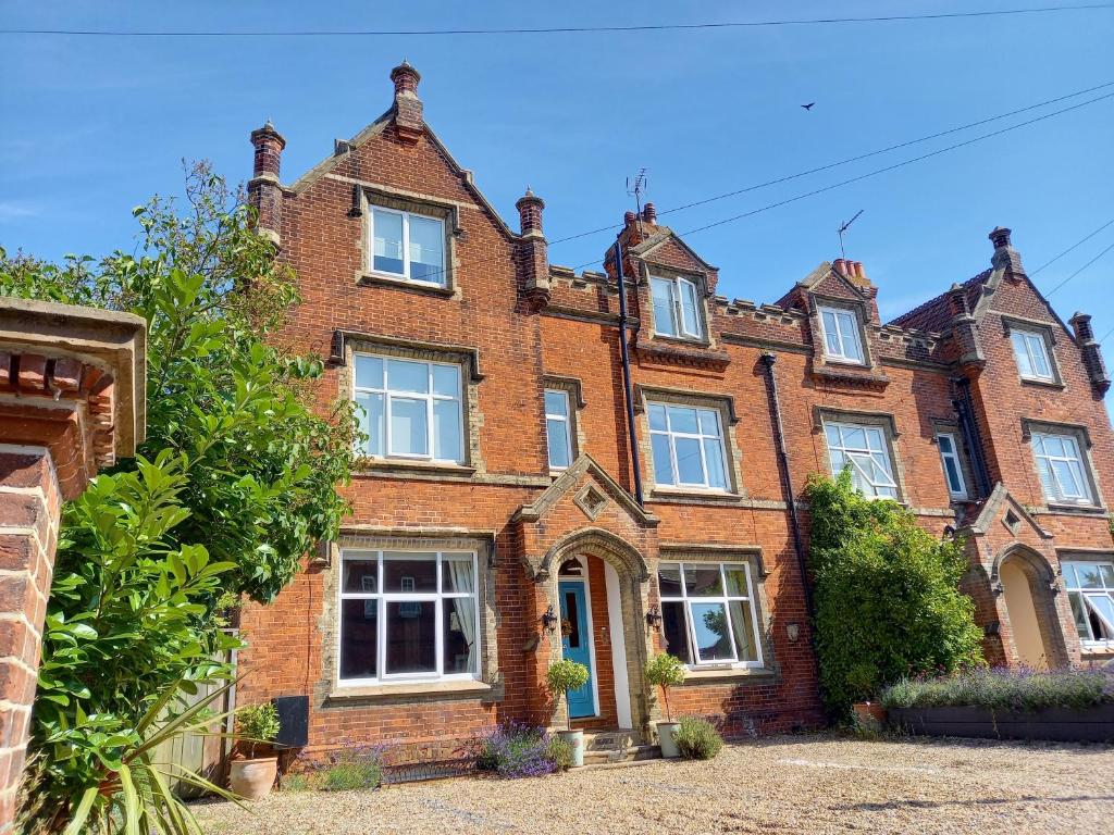 a large red brick house with white windows at No4 Cromer in Cromer