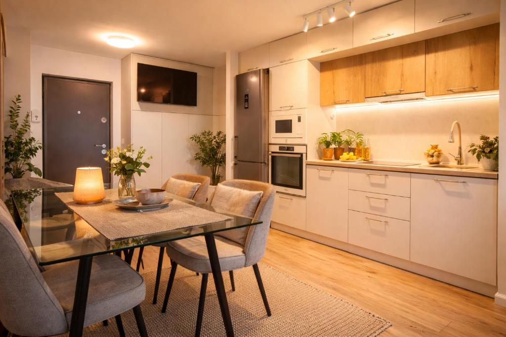 a kitchen and dining room with a table and chairs at FF Residence in Deva