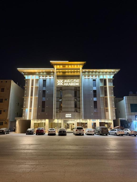 a large building with cars parked in a parking lot at اكارم - إشبيلية - Akarem - iishbilia - اقتصادي in Riyadh