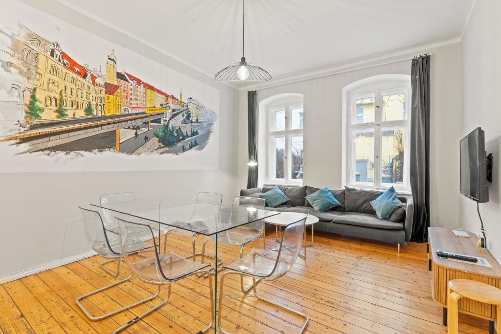 a living room with a glass table and a couch at primeflats - Apartments Genter Berlin-Wedding in Berlin