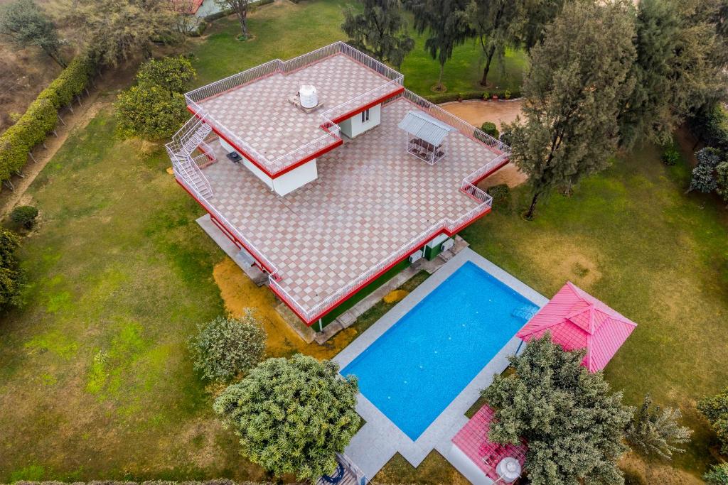 an overhead view of a house with a swimming pool at Alaya Stays Luxe FarmAcre Pet-friendly 4-BHK Villa With Private Pool, Garden & Terrace in Gurgaon
