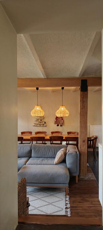 a living room with a couch and a table at L'Eaubergerine in Herbeumont