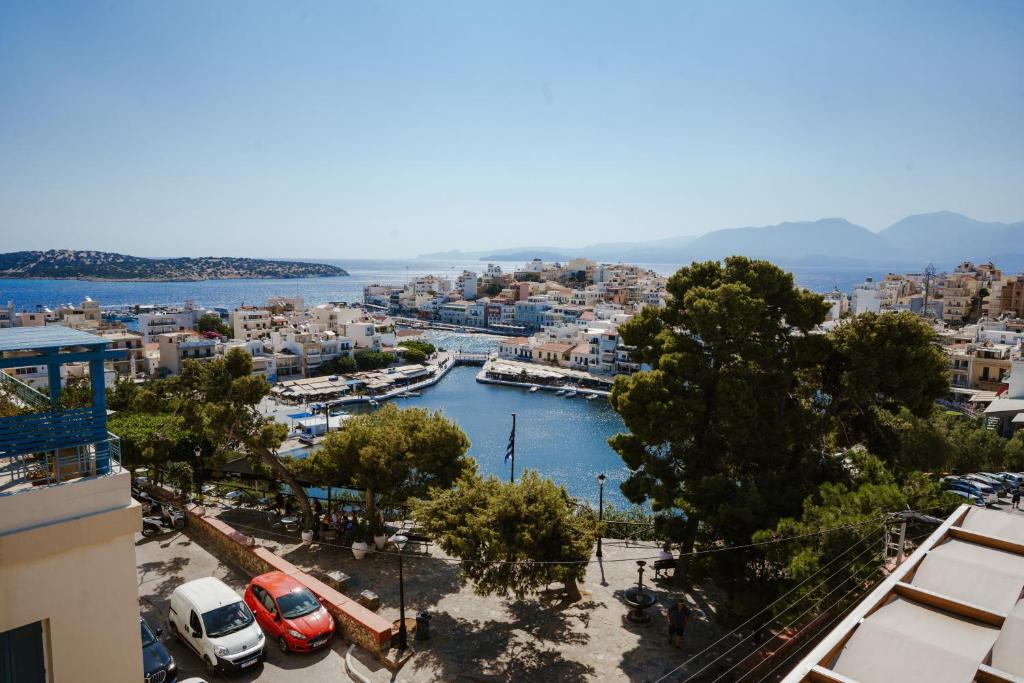 a view of a city with cars parked in a harbor at Wake in the Lake III in Agios Nikolaos