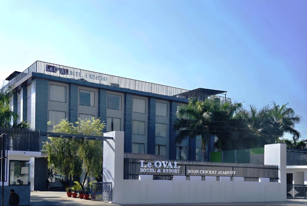 a building with a sign in front of it at Le OVAL Hotel & Resorts in Nakraunda