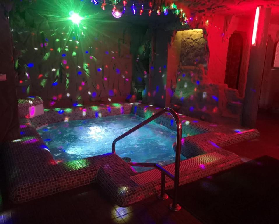 a jacuzzi tub in a room with christmas lights at Eden Garden Sovata in Sovata