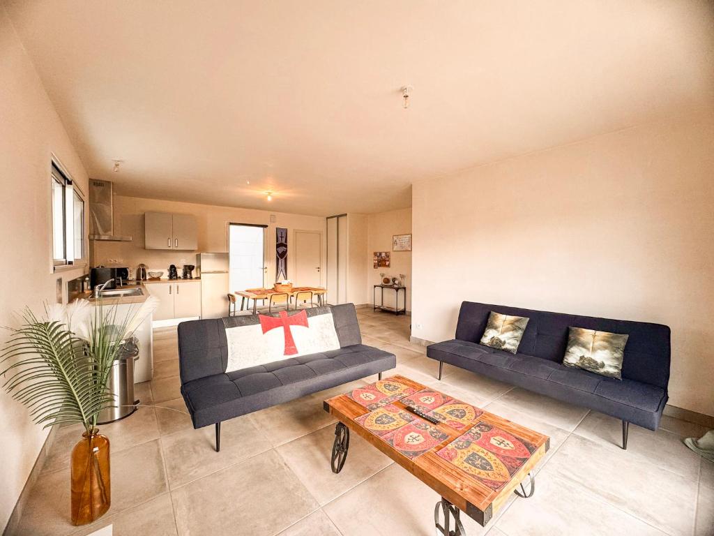 a living room with a couch and a table at Maison 5-6 personnes -15 min du Parc - Parking -by R&G in La Pommeraie-sur-Sèvre