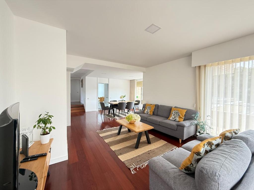 a living room with a couch and a table at Secret Spot Apartment - Quinta da Barca in Esposende