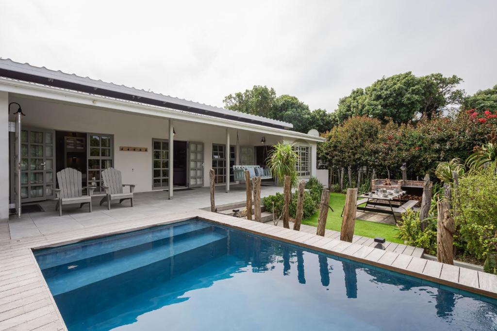 a swimming pool in the backyard of a house at The Oyster Shack by The Oyster Collection in Kenton on Sea