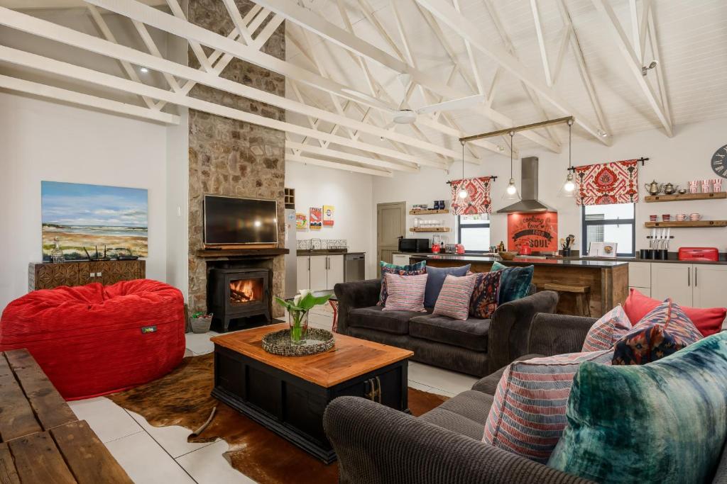 a living room with couches and a fireplace at Ocean Breeze by The Oyster Collection in Kenton on Sea
