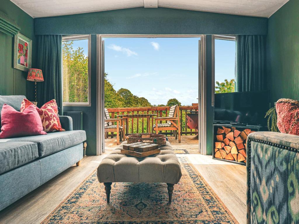 a living room with a couch and a large window at The Herdsman - Uk50615 in Sabden