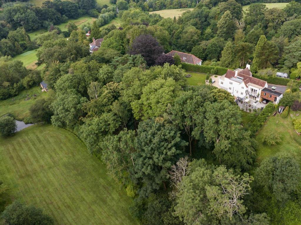 an aerial view of a house on a hill with trees at 5 Bed in Devizes oc-s34742 in Devizes