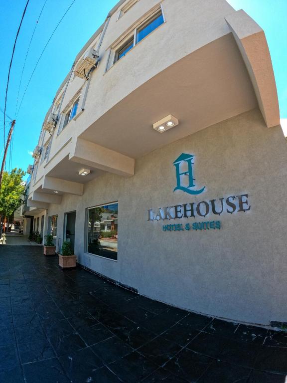 a building with a sign on the side of it at LakeHouse Hotel & Suites in Villa Carlos Paz