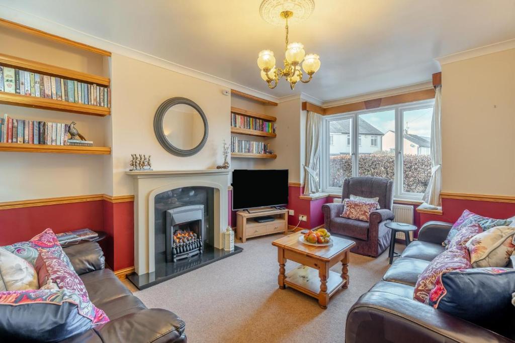 a living room with a fireplace and a tv at 3 Bed in Portinscale oc-w31059 in Portinscale