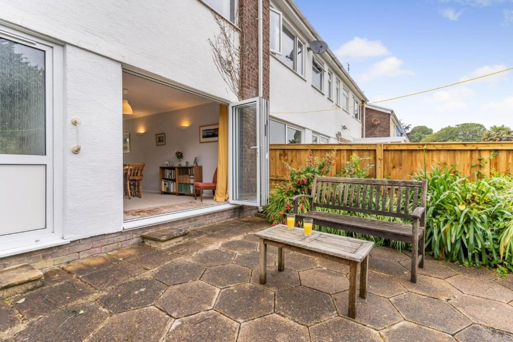 a patio with a bench and a table at 2 Bed in Mumbles oc-d32021 in The Mumbles