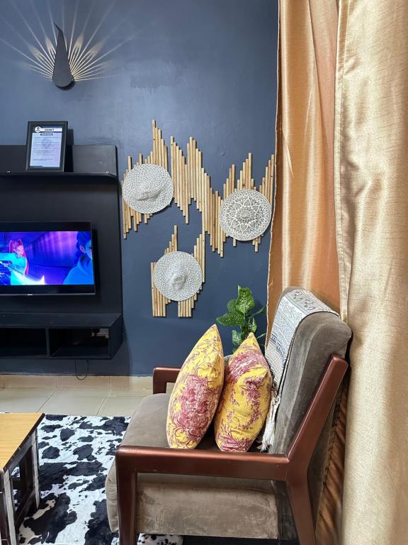a living room with a couch and a tv at Ekinot homes in Lira