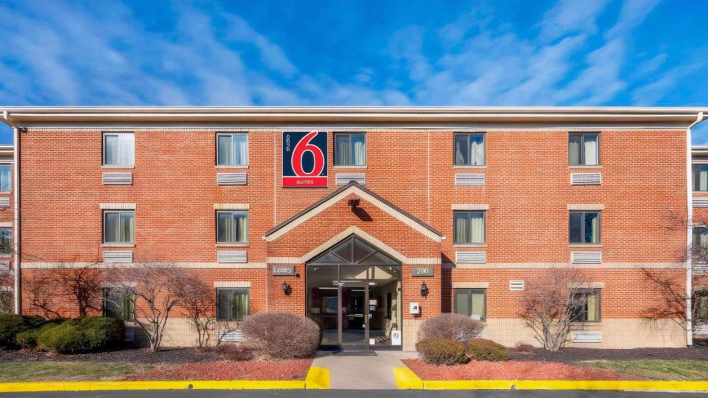 a red brick building with a sign on it at Studio 6 Extended Stay Florence KY - Meijer Dr Cincinnati in Florence