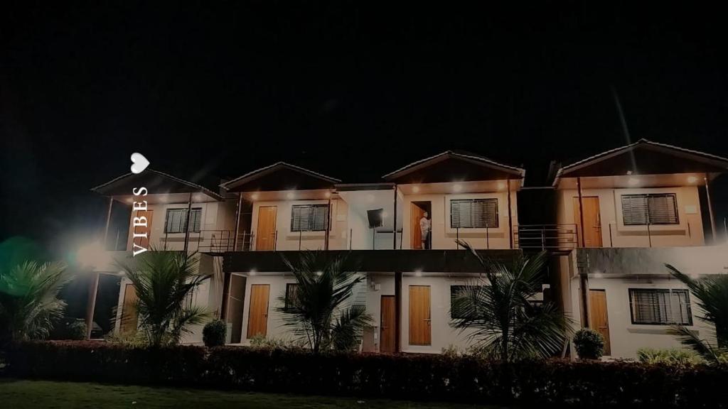 a house at night with a sign on it at Shri Balaji Resort in Ellora