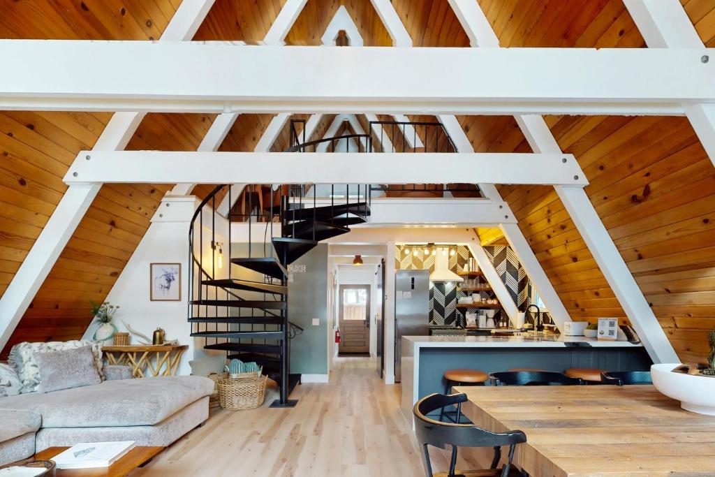 a spiral staircase in a living room with wooden ceilings at Elati Escape in South Lake Tahoe
