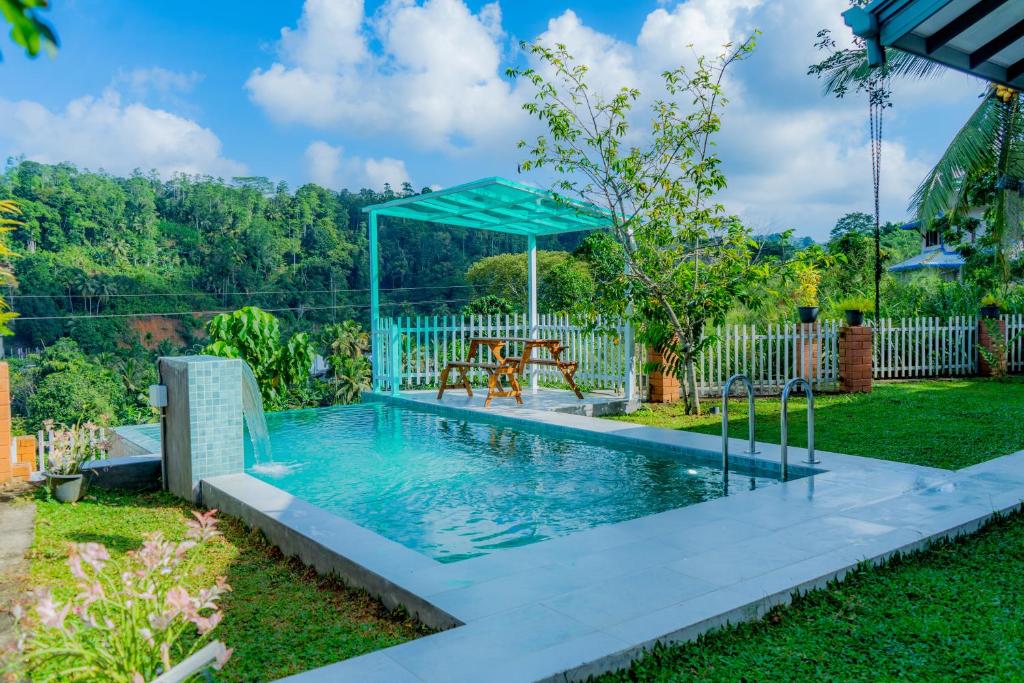 a swimming pool in a yard with a gazebo at Rose Villa by Kananke Hills in Kananke