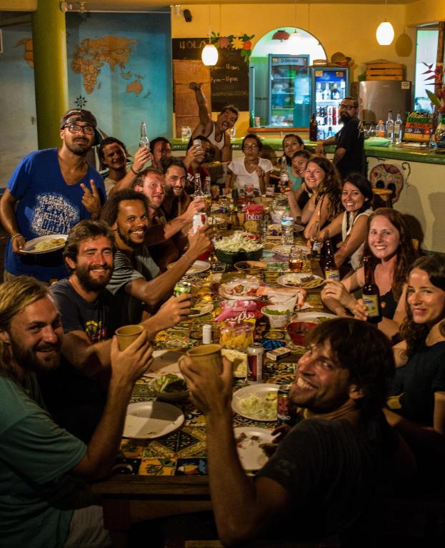 a group of people sitting around a long table at Casa Losodeli & Coworking- Adults Only in Puerto Escondido