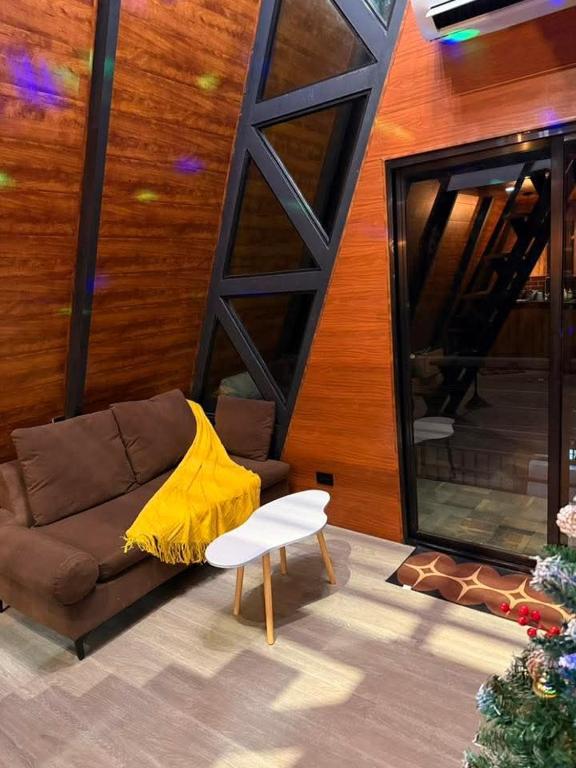 a living room with a couch and a yellow blanket at Tasha's Place in Antipolo