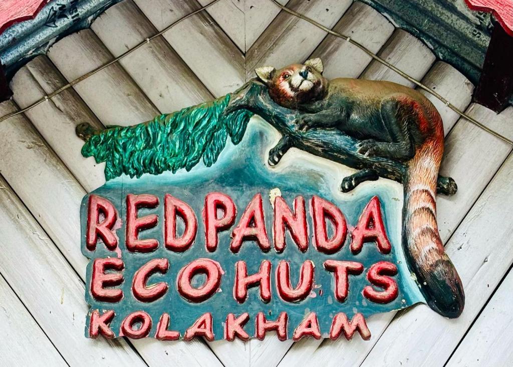 a sign for a red panda ecoptics kochatown at Red Panda Ecohut in Lava