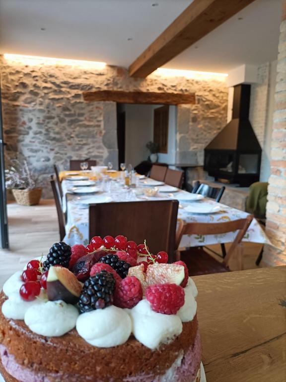 a cake with fruit on top of it on a table at Can Freixa in Sant Pere de Torelló