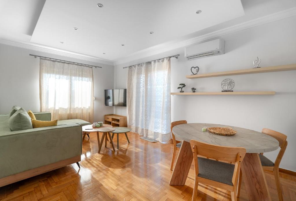 a living room with a table and a couch at Zeas Yacht View in Piraeus