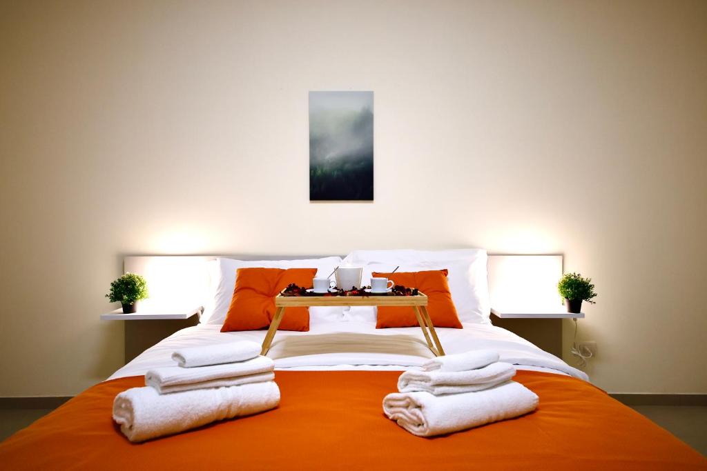 a bedroom with a bed with towels on it at Ètoile Palace Gravina in Gravina in Puglia