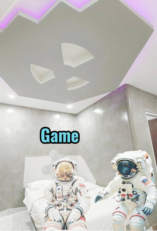 two astronauts in a room with the words game at Hoft Hotel Ramkhamhaeng24 in Sathani Khlong Tan