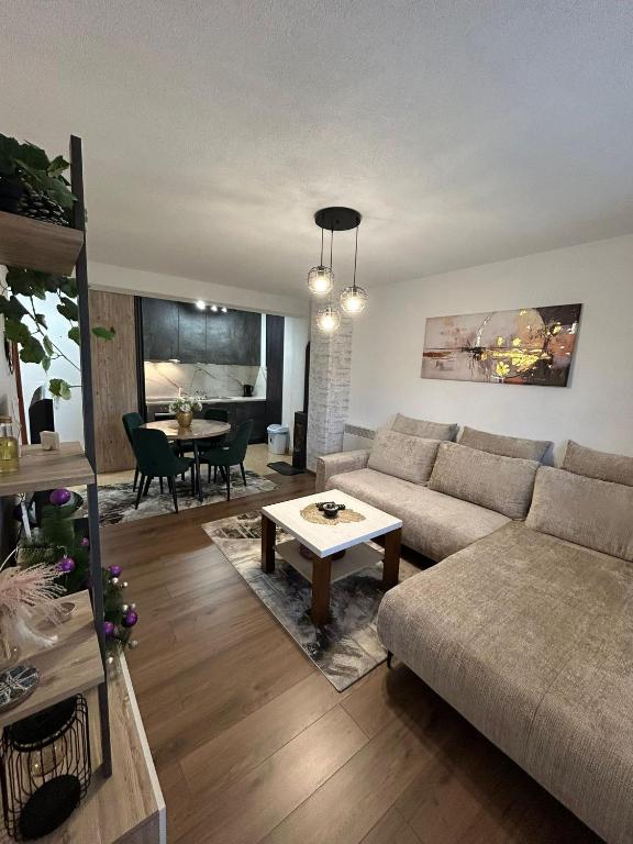 a living room with a couch and a table at Apartman Montis in Kupres