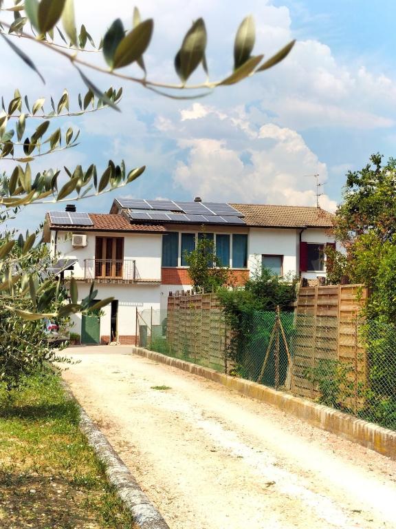 a house with solar panels on a dirt road at La Quiete appartamento in campagna a Spoleto in Spoleto