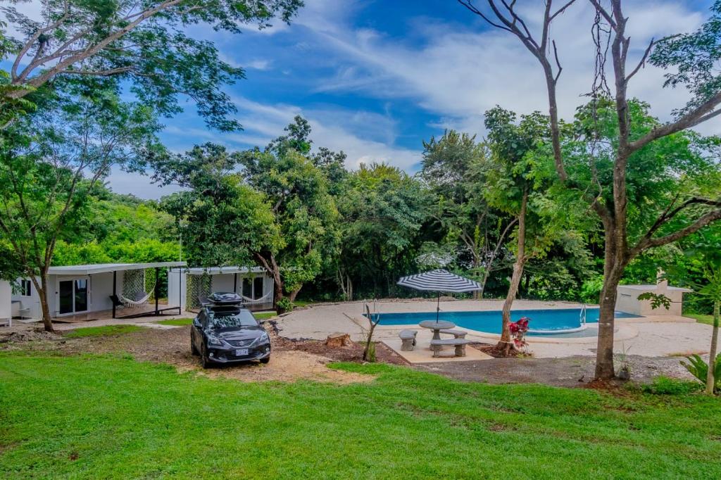 a house with a car parked in front of a yard at Tierra de Gosén in Santa Cruz