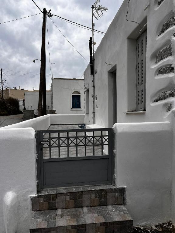a white building with a door and a balcony at Gala Home Traditional house in Galanádhon