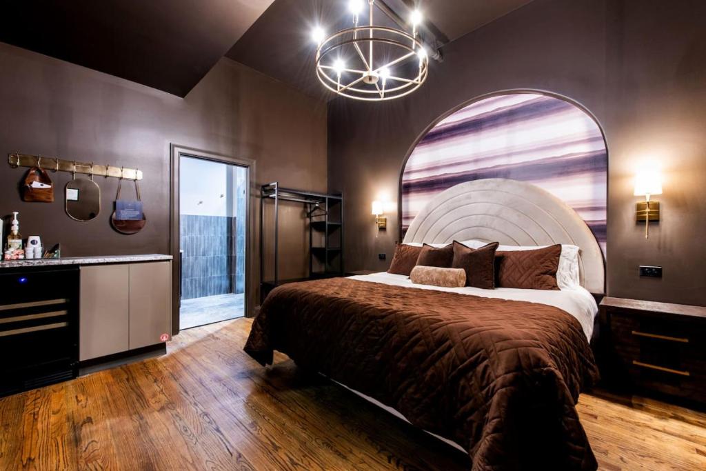 a bedroom with a large bed and a large window at Hollyhock Suite 412 in Louisville