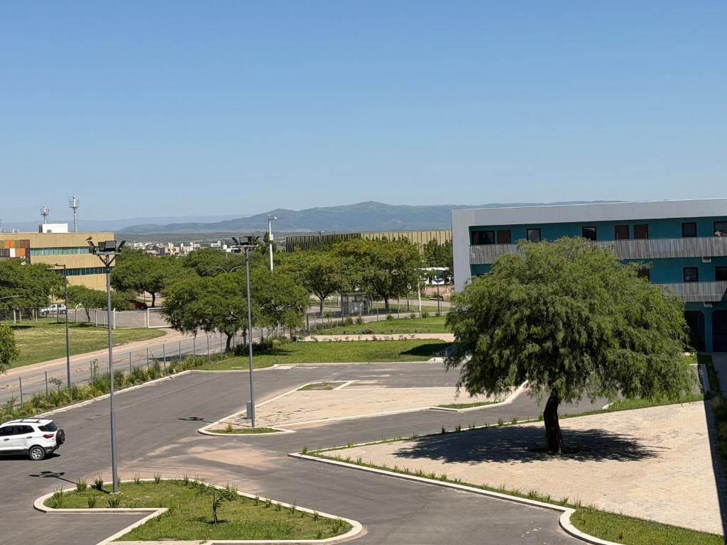 a parking lot with a tree in the middle of a street at Apart Lunge in Córdoba
