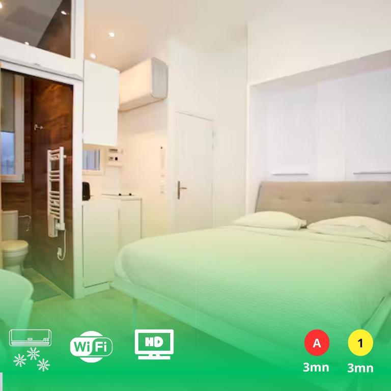 a white bedroom with a bed and a bathroom at Rempart du Chateau-SV85 StudioVincennes in Vincennes