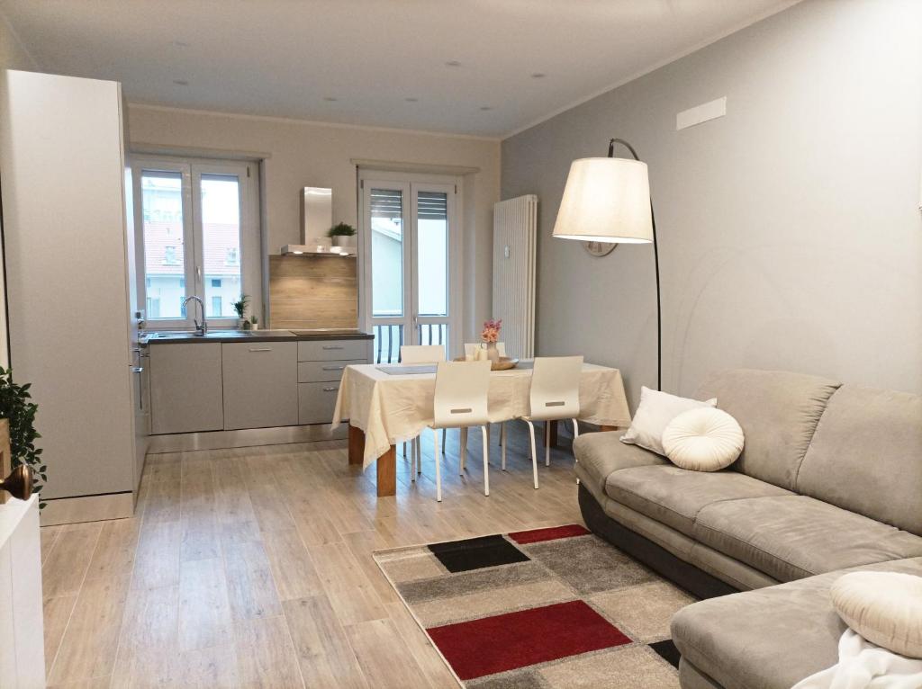 a living room with a couch and a table at Quick Home - Edera in Biella