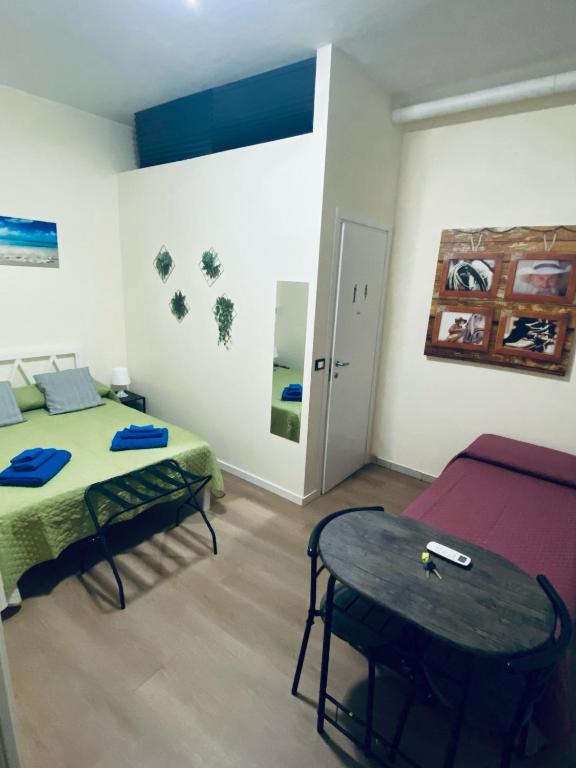 a room with a bed and a table in it at Affittacamere Nel Cuore di Faenza in Faenza