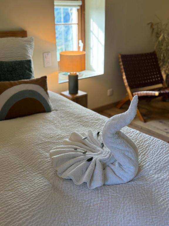 a towel animal is sitting on a bed at le moulin de l oliveraie in Blausasc