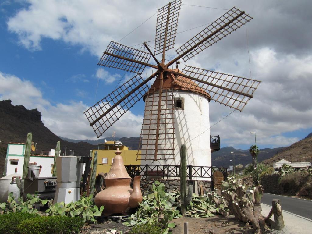 a white windmill sitting in the middle of a street at Apartamento " El Pueblo" in Mogán
