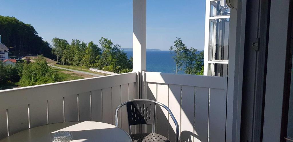a balcony with a table and a view of the ocean at "Residenz Seeblick" Studio 23 mit seitlichem Ostseeblick in Ostseebad Sellin