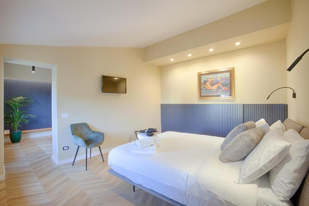 a bedroom with a large white bed and a chair at 1029 GuestHouse in Sora