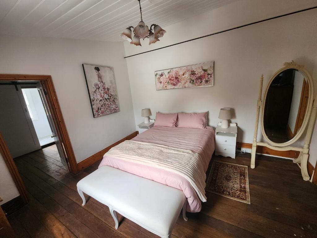 a bedroom with a large bed and a window at Viveash - Historic accommodation with Ensuite in Hoddy Well