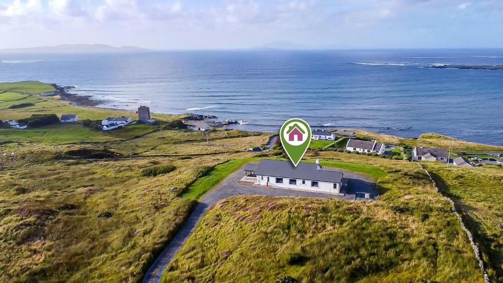 an overhead view of a house on a hill next to the ocean at Makeelan House in Renvyle
