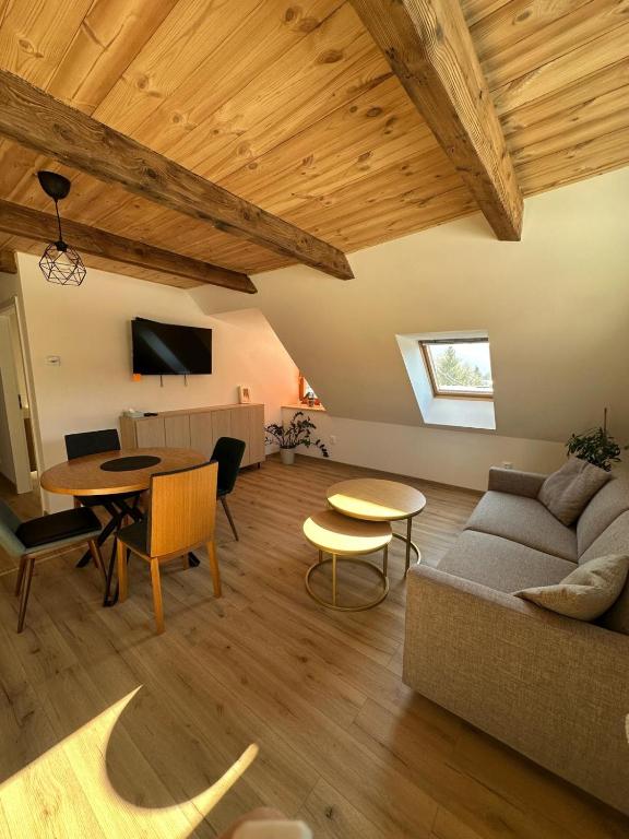 a living room with a couch and a table at Brezový dvor in Svätý Anton