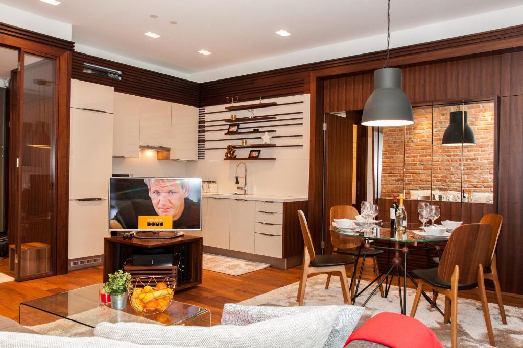 a kitchen and dining room with a table and a dining room at Centroom Apartment Zagreb in Zagreb
