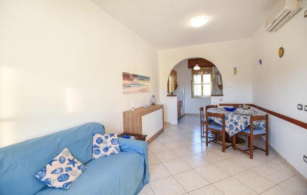 a living room with a blue couch and a table at Casa Vincenzo in Satriano